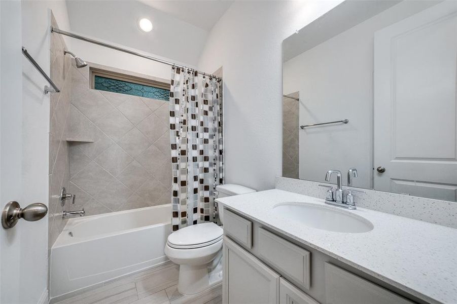 SECONDARY BATH WITH SPECIALTY WINDOW COVERING, QUARTZ COUNTERS & LINEN CLOSET (NOT SHOWN BEHIND DOOR)