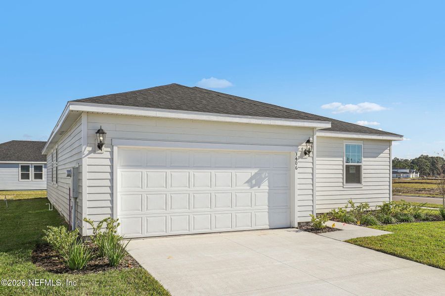 Front exterior of a new home in Lakes at Bella Lago - Signature Series, Green Cove Springs, FL, highlighting curb appeal (Image 2). Front exterior of a new home in Lakes at Bella Lago - Signature Series, Green Cove Springs, FL, highlighting curb appeal (Image 2).