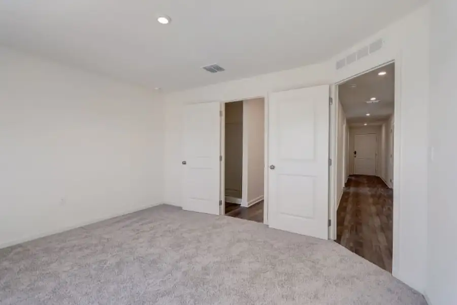 A hallway with white doors.