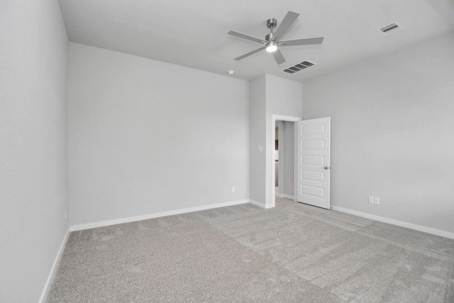 Escape and relax in the exquisite primary suite, a haven to unwind after a long day. The spacious room, boasts plush carpeting, soothing paint tones, high ceilings, and expansive windows adorned with privacy blinds. Sample photo of completed home with similar floor plan. Actual colors and selections may vary. Escape and relax in the exquisite primary suite, a haven to unwind after a long day. The spacious room, boasts plush carpeting, soothing paint tones, high ceilings, and expansive windows adorned with privacy blinds. Sample photo of completed home with similar floor plan. Actual colors and selections may vary.