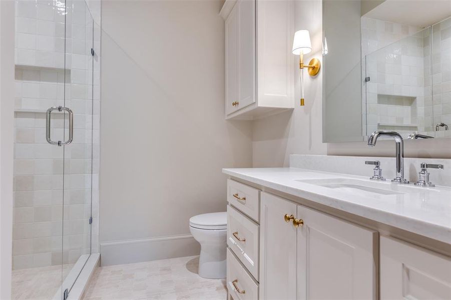 Bathroom with vanity, a shower stall, and light tile patterned floors Bathroom with vanity, a shower stall, and light tile patterned floors