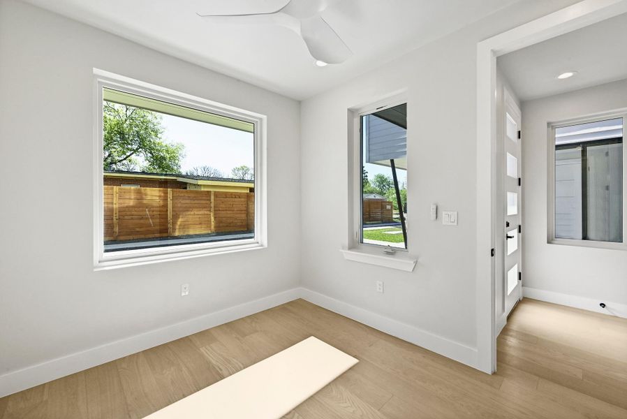 1st Floor Bedroom with tons of natural light. (This is Unit #2 - each Unit has the same layout, however a few differing details such as light fixtures, custom cabinet/backsplash/tile colors)