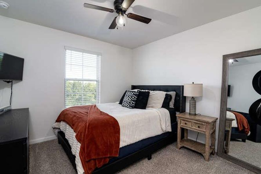 Bedroom with carpet and ceiling fan
