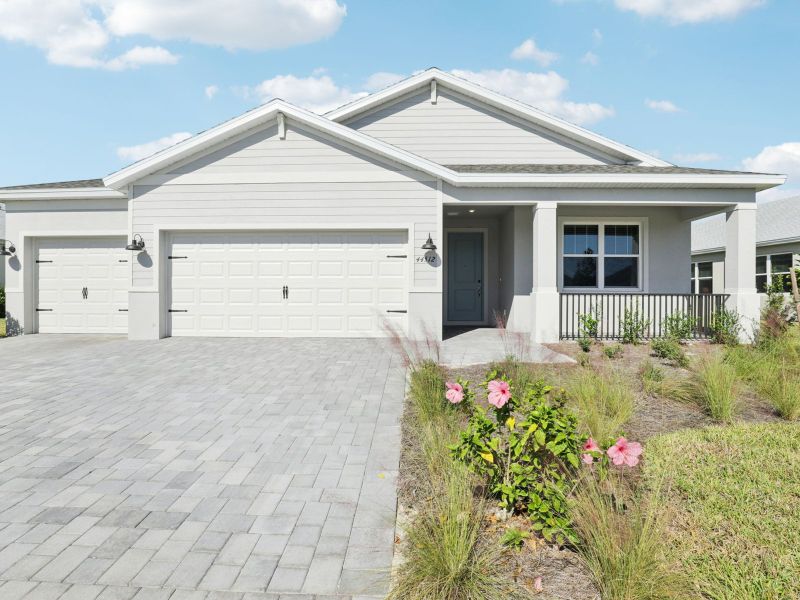 Front exterior of a new home in Crescent Lakes - Signature Series, Punta Gorda, FL, highlighting curb appeal (Image 1).