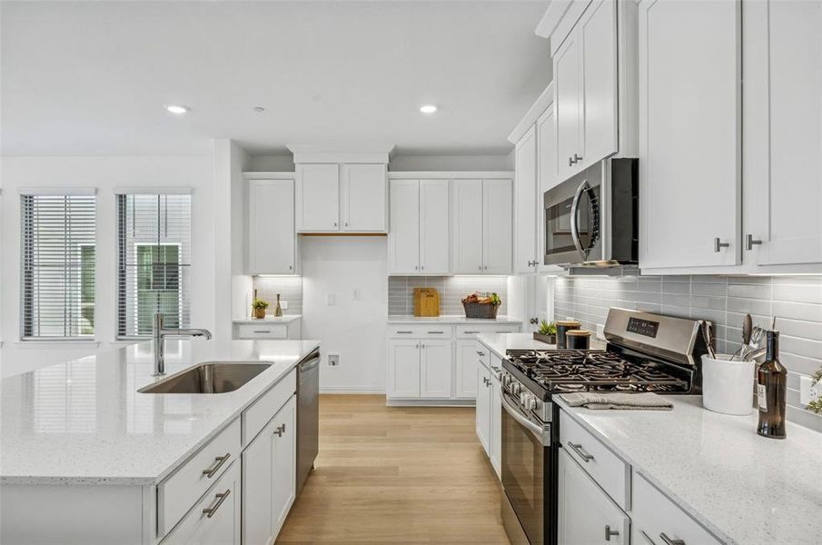 A beautiful backsplash, stainless appliances, pot & pan drawers and so much more can be found in this over the top kitchen!