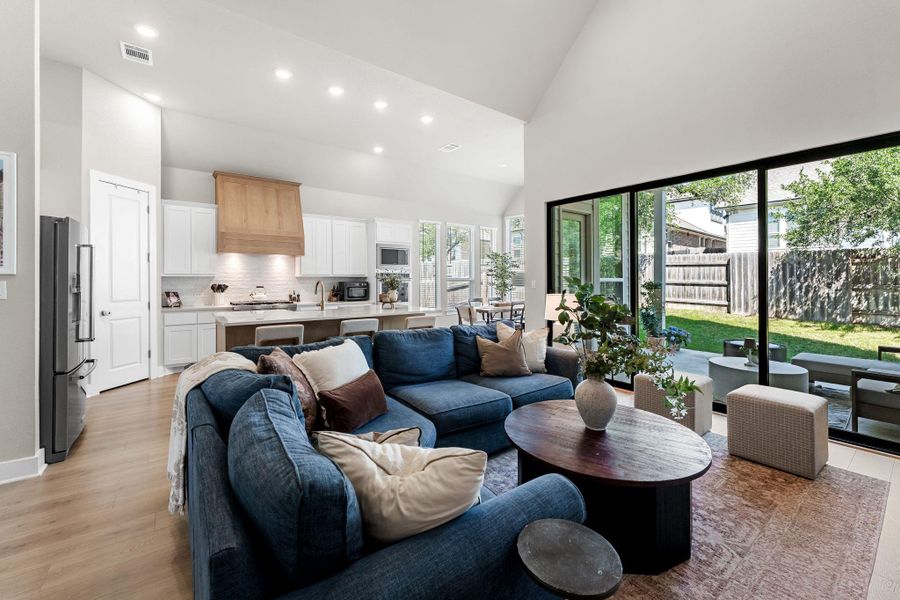 Expansive living area featuring vaulted ceilings and light wood-finish flooring