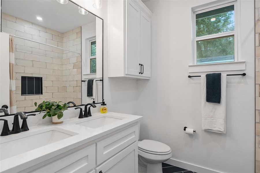 Hall bathroom near bedrooms 2 and 3 with dual sinks. Hall bathroom near bedrooms 2 and 3 with dual sinks.