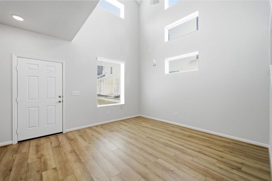 Entryway with light wood-style flooring and a high ceiling