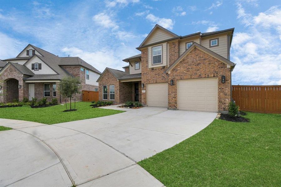 Home showcases a convenient 2-car garage paired with a spacious driveway, providing ample room for parking.