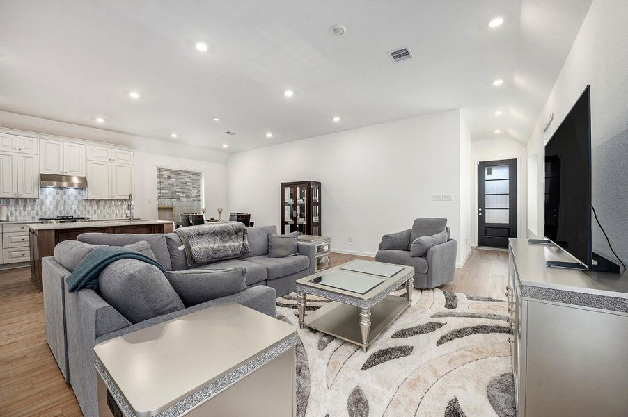 Spacious living area with large windows and recessed lighting—perfect for relaxing or hosting Spacious living area with large windows and recessed lighting—perfect for relaxing or hosting