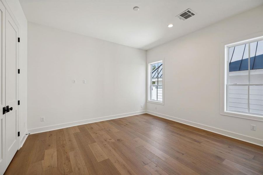 One of 3 upstairs secondary bedrooms each with fantastic closet, private ensuite bath and engineered white oak hardwood floors.