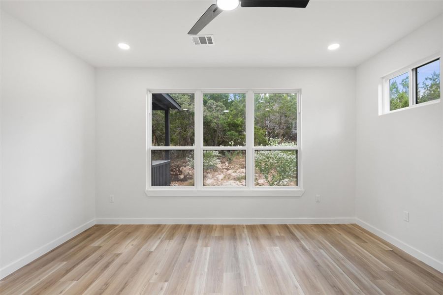 Spare room with light wood-style flooring, a ceiling fan, and recessed lighting Spare room with light wood-style flooring, a ceiling fan, and recessed lighting