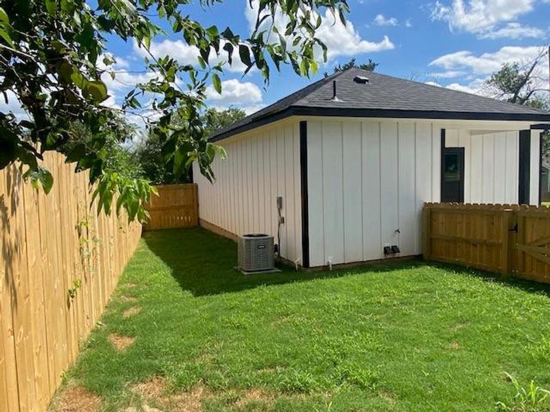 A well-maintained lawn embraces this crisp, modern home, privately enclosed by a new wooden fence. A well-maintained lawn embraces this crisp, modern home, privately enclosed by a new wooden fence.