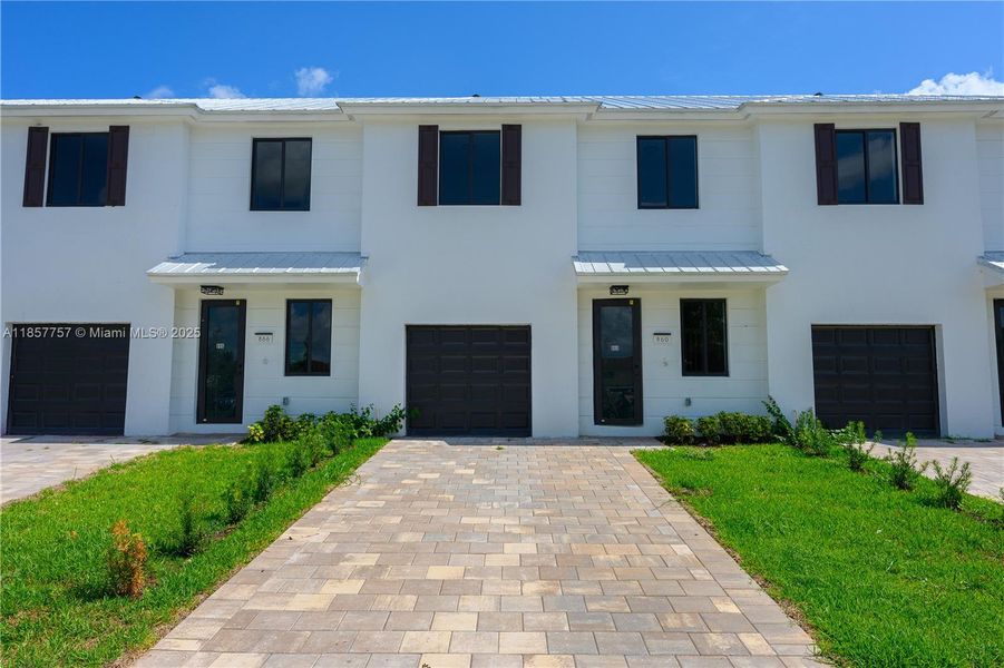 Front exterior of a new home in , Florida City, FL, highlighting curb appeal (Image 25). Front exterior of a new home in , Florida City, FL, highlighting curb appeal (Image 25).