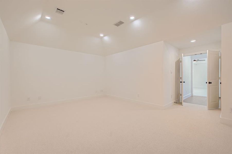 Spare room with light colored carpet