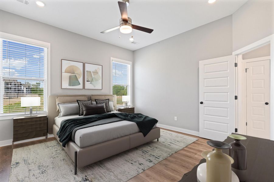 Bedroom featuring light wood-type flooring, a ceiling fan, and recessed lighting