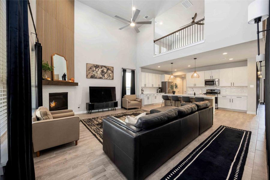 Alternate angle of living area showcasing seamless flow into the kitchen and dining spaces. Alternate angle of living area showcasing seamless flow into the kitchen and dining spaces.