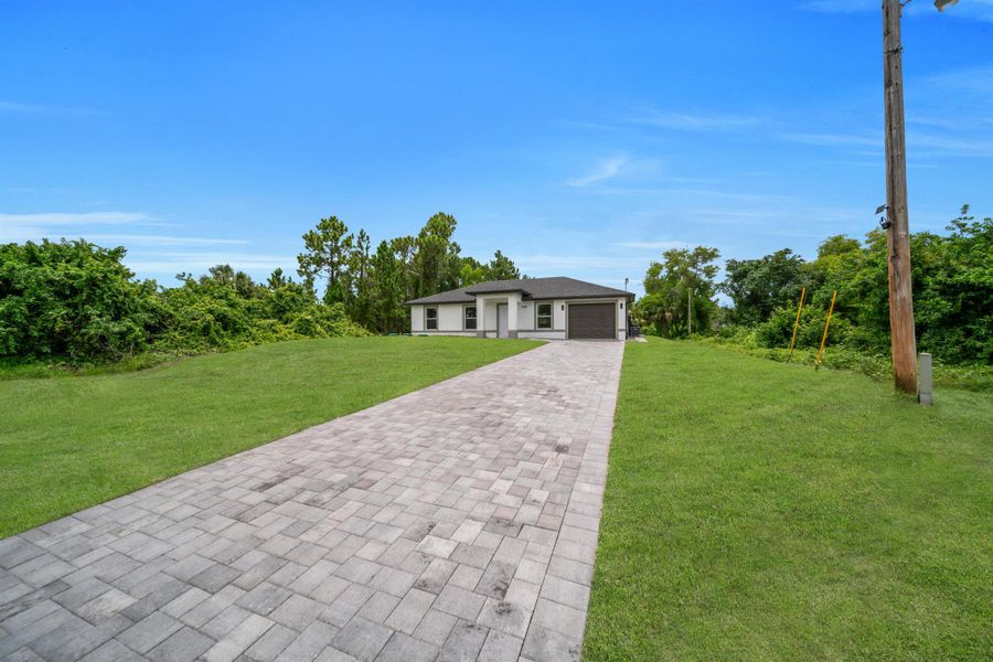 Front exterior of a new home in , Lehigh Acres, FL, highlighting curb appeal (Image 2). Front exterior of a new home in , Lehigh Acres, FL, highlighting curb appeal (Image 2).