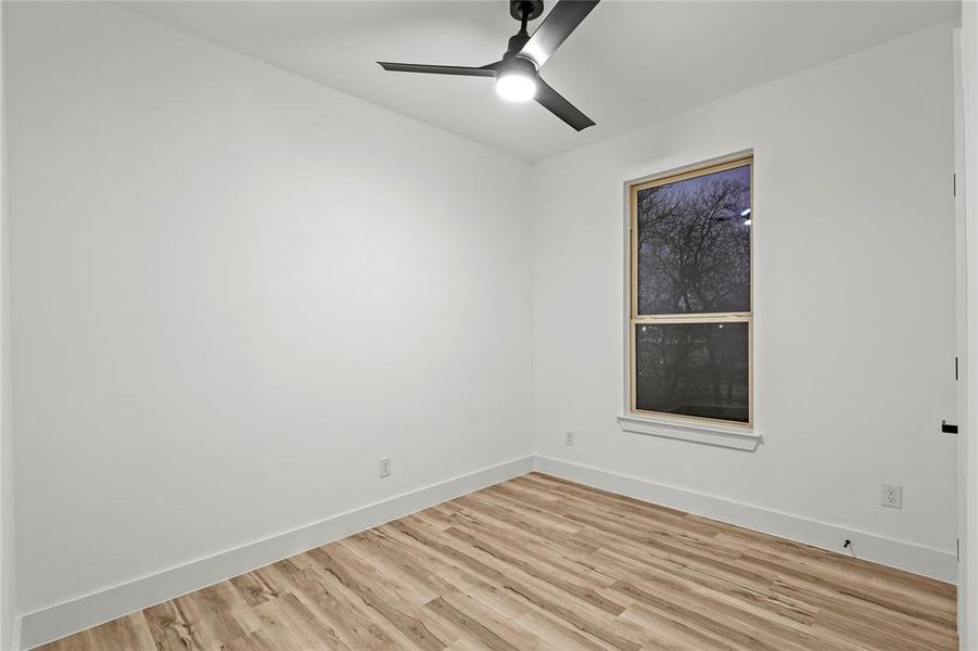 Empty room featuring ceiling fan and light wood-type flooring