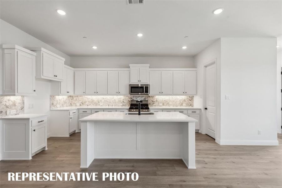 The oversized kitchen island is the perfect place for friends and family to gather round. REPRESENTATIVE PHOTO The oversized kitchen island is the perfect place for friends and family to gather round. REPRESENTATIVE PHOTO