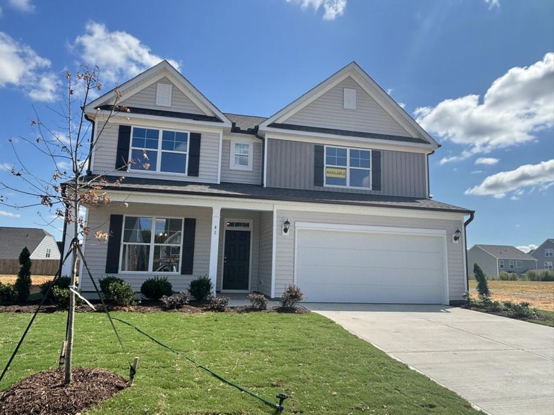 Front exterior of a new home in Daniel Farms, Benson, NC, highlighting curb appeal (Image 2).