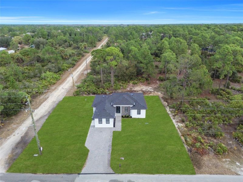 Front exterior of a new home in , Lehigh Acres, FL, highlighting curb appeal (Image 26).
