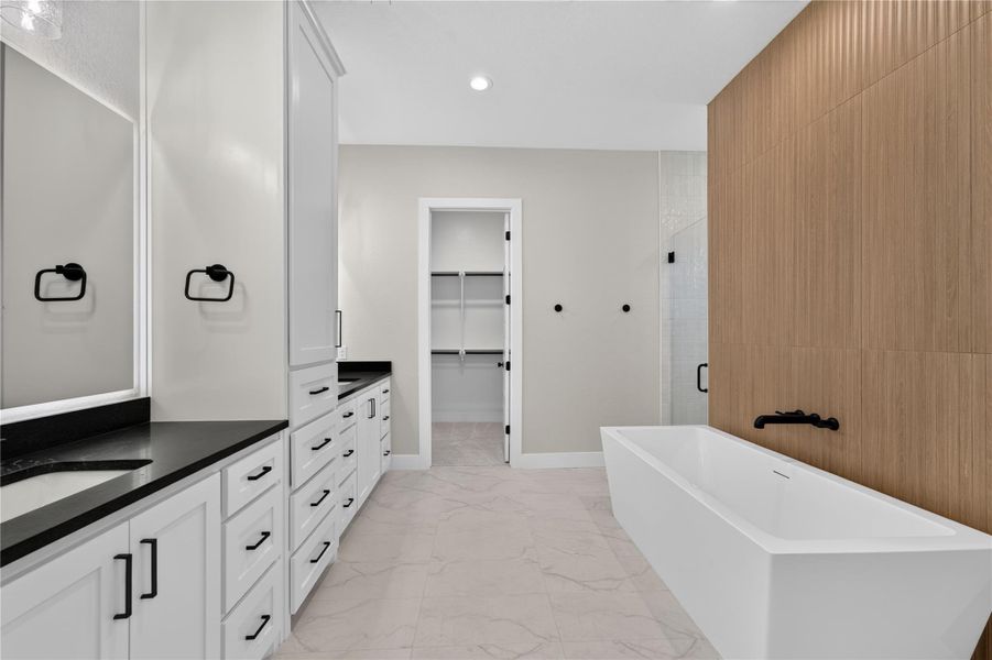 Clean lines and a freestanding tub define this contemporary primary bath oasis.