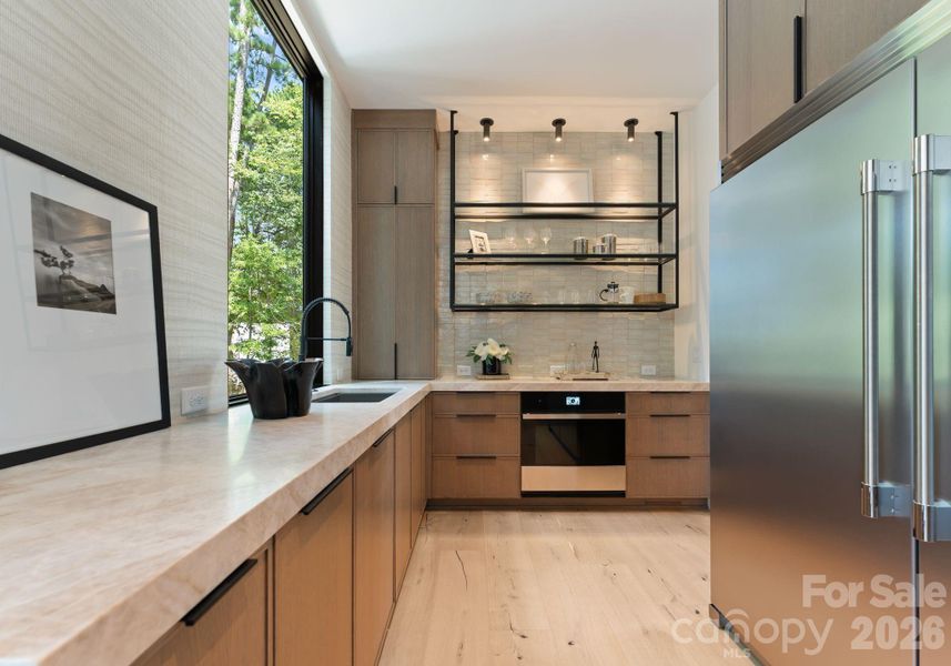 Scullery featuring additional appliances and a walk-in pantry. Scullery featuring additional appliances and a walk-in pantry.