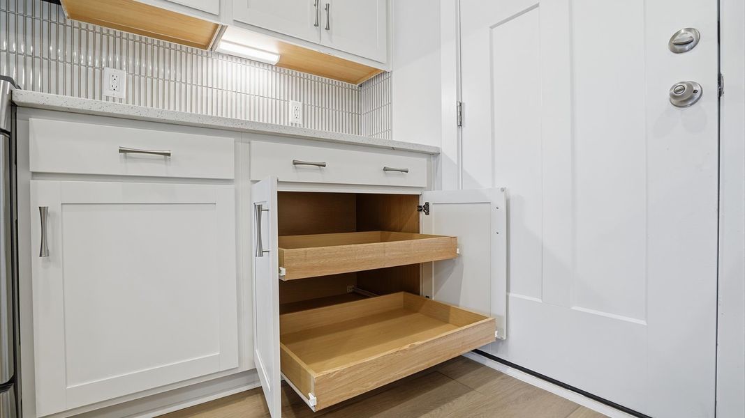 Bright and welcoming kitchen with carefully selected finishes and ample storage at Village at Midway