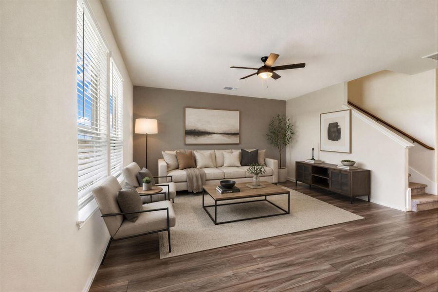 Hardwood-style flooring extends through this comfortable living space, centered by a modern ceiling fan. Virtually Staged Hardwood-style flooring extends through this comfortable living space, centered by a modern ceiling fan. Virtually Staged