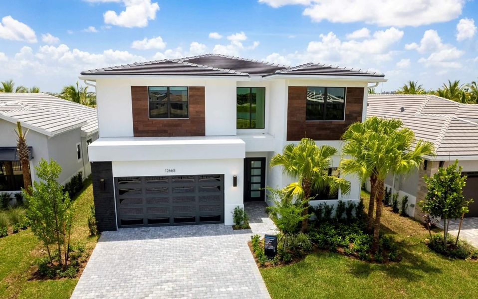 Front exterior of a new home in Solana Bay at Avenir, Palm Beach Gardens, FL, highlighting curb appeal (Image 2).
