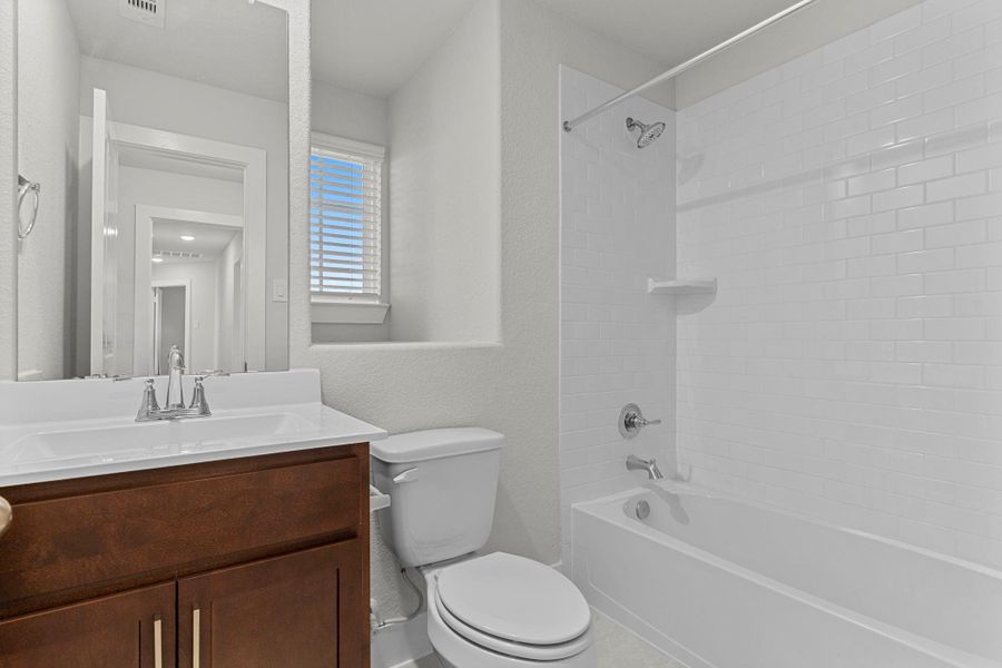 The secondary bath offers sleek style and convenience, featuring a full tub/shower combination, modern fixtures, and plenty of lighting—perfect for shared or guest use. The secondary bath offers sleek style and convenience, featuring a full tub/shower combination, modern fixtures, and plenty of lighting—perfect for shared or guest use.