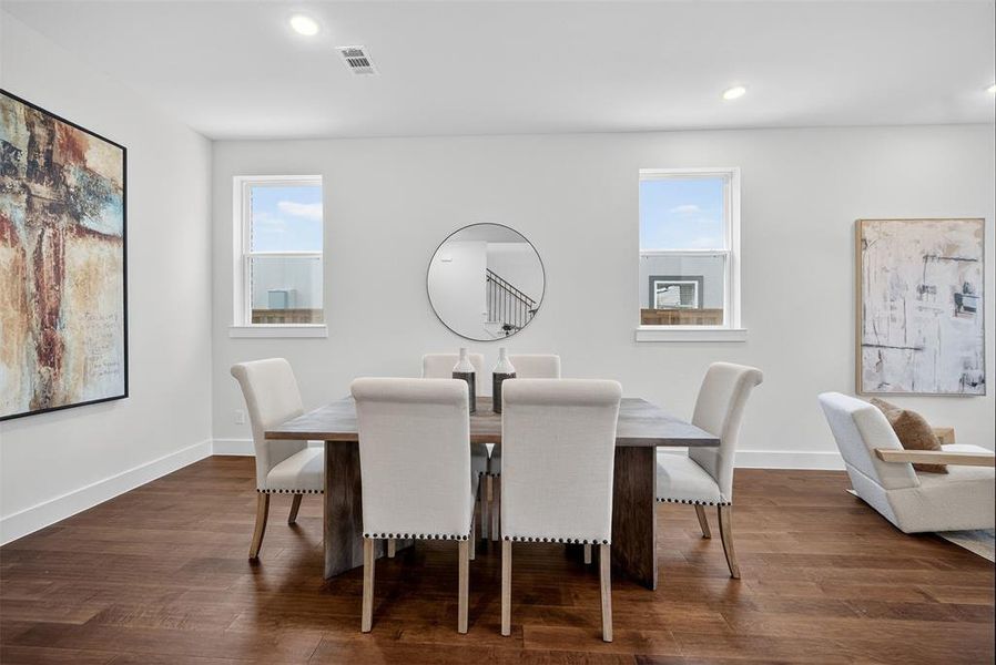 Dining space featuring dark wood-type flooring and recessed lighting