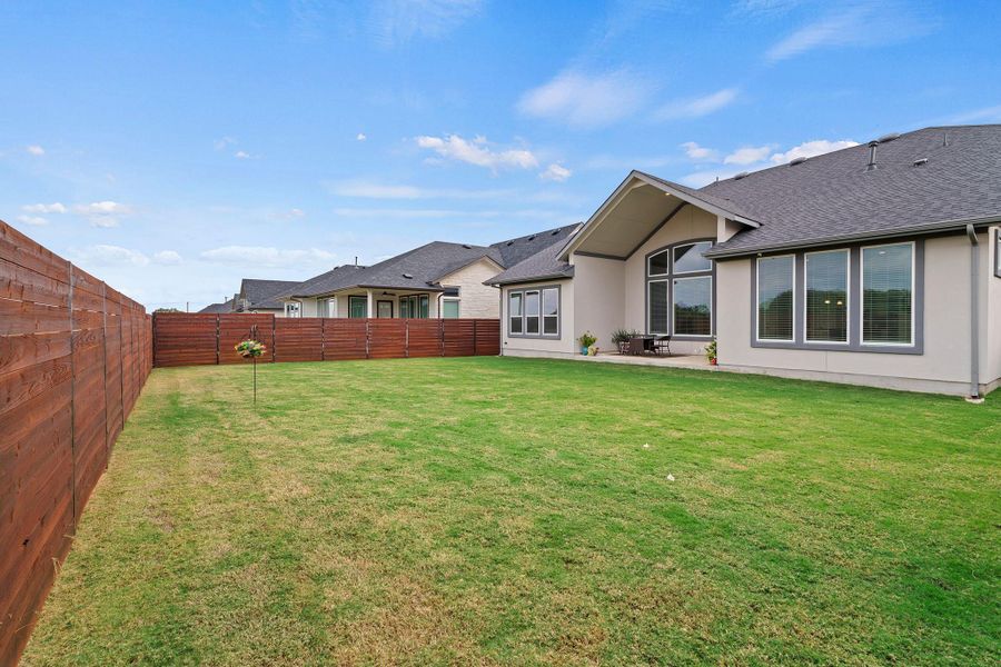 Fenced backyard featuring a patio Fenced backyard featuring a patio
