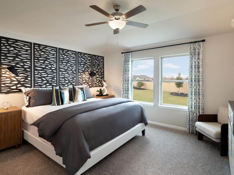 Carpeted bedroom with baseboards and ceiling fan