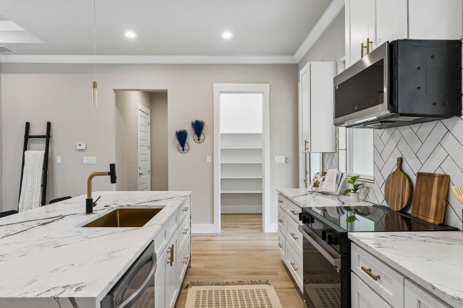 Culinary excellence awaits with a large kitchen island, gleaming countertops, and modern appliances.