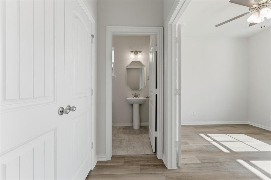 Hall featuring light wood-style flooring and baseboards