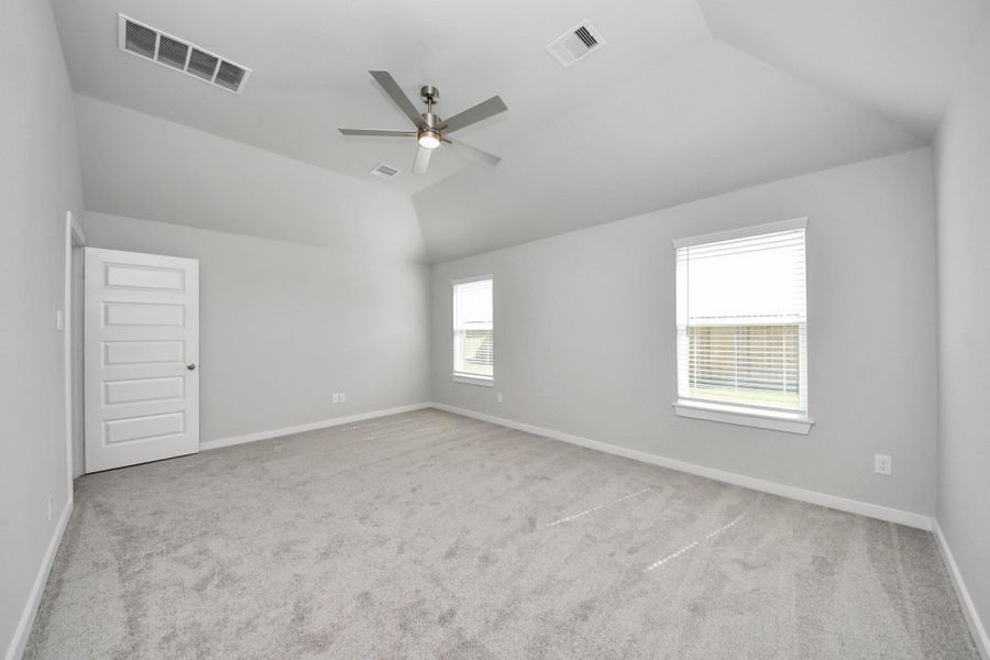 Escape to tranquility in this spacious primary room, adorned with plush carpeting and bathed in the soothing hues of warm paint colors, creating a cozy retreat for relaxation. Sample photo of completed home with similar floor plan. Actual colors and selections may vary. Escape to tranquility in this spacious primary room, adorned with plush carpeting and bathed in the soothing hues of warm paint colors, creating a cozy retreat for relaxation. Sample photo of completed home with similar floor plan. Actual colors and selections may vary.