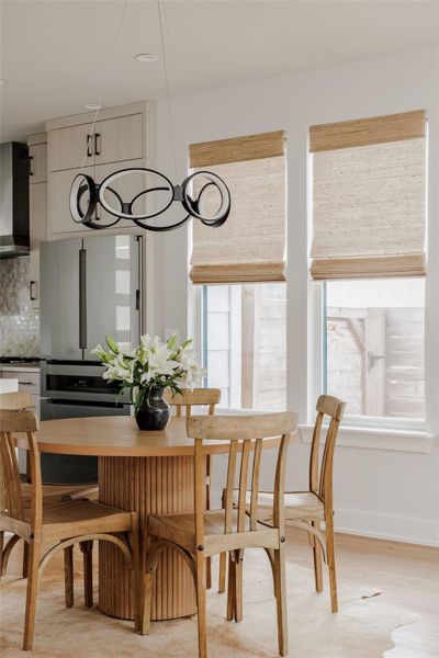 Dining space featuring light wood-style floors and healthy amount of natural light
