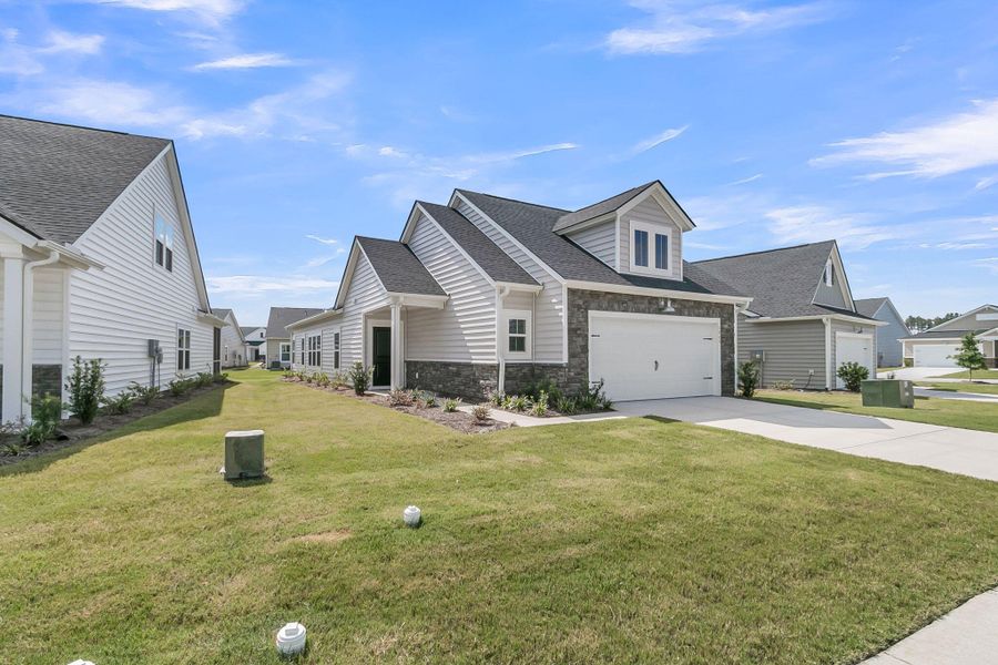 Front exterior of a new home in Horizons at Summers Corner | 55+: The Cottages, Summerville, SC, highlighting curb appeal (Image 27). Front exterior of a new home in Horizons at Summers Corner | 55+: The Cottages, Summerville, SC, highlighting curb appeal (Image 27).