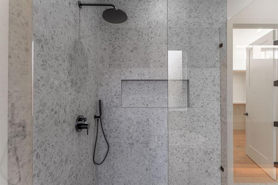 Interior details featuring hardwood / wood-style flooring and tiled shower