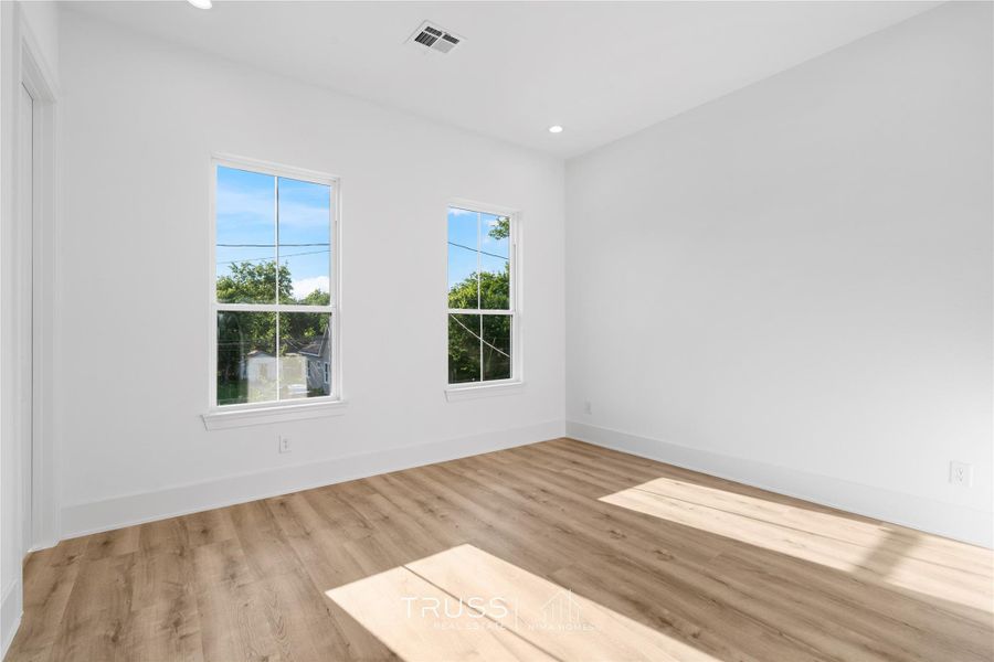 Front-facing windows invite morning light and quiet neighborhood views, blending warmth and urban refinement.
