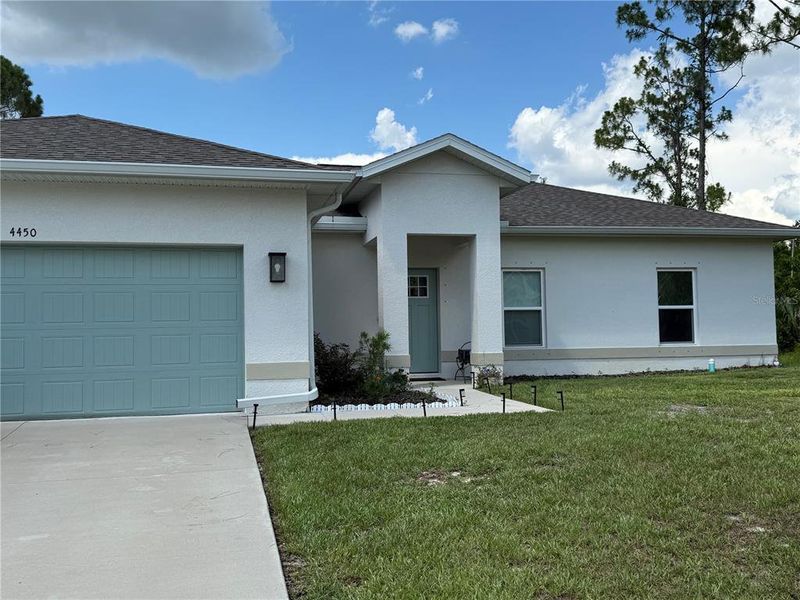 Front exterior of a new home in , North Port, FL, highlighting curb appeal (Image 1). Front exterior of a new home in , North Port, FL, highlighting curb appeal (Image 1).