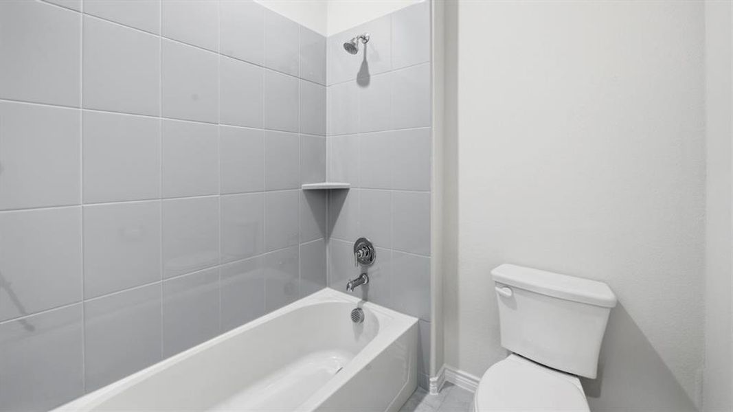 Full bathroom with shower / tub combination and toilet Full bathroom with shower / tub combination and toilet