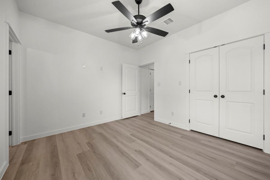 Laminate flooring throughout offers a clean, contemporary feel, anchored by a central ceiling fan for comfort. Laminate flooring throughout offers a clean, contemporary feel, anchored by a central ceiling fan for comfort.