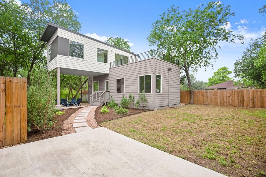 Contemporary architecture featuring a multi-level design with light-toned siding