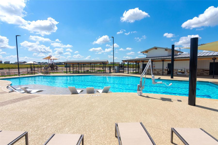 Expansive outdoor swimming pool with integrated seating and a broad deck