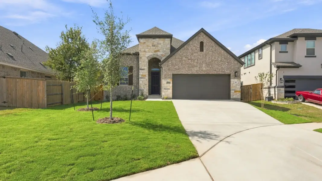 Front exterior of a new home in Oaks at San Gabriel, Georgetown, TX, highlighting curb appeal (Image 22).