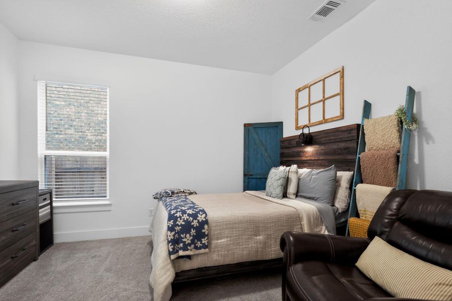Bedroom featuring light gray carpeting, a window with blinds, and white walls Bedroom featuring light gray carpeting, a window with blinds, and white walls