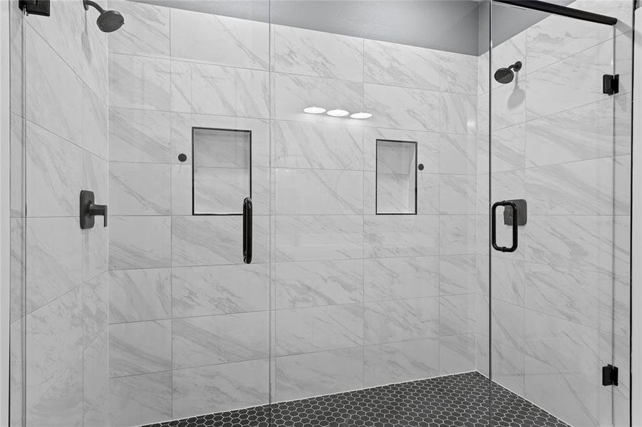 Full bathroom featuring a shower stall Full bathroom featuring a shower stall